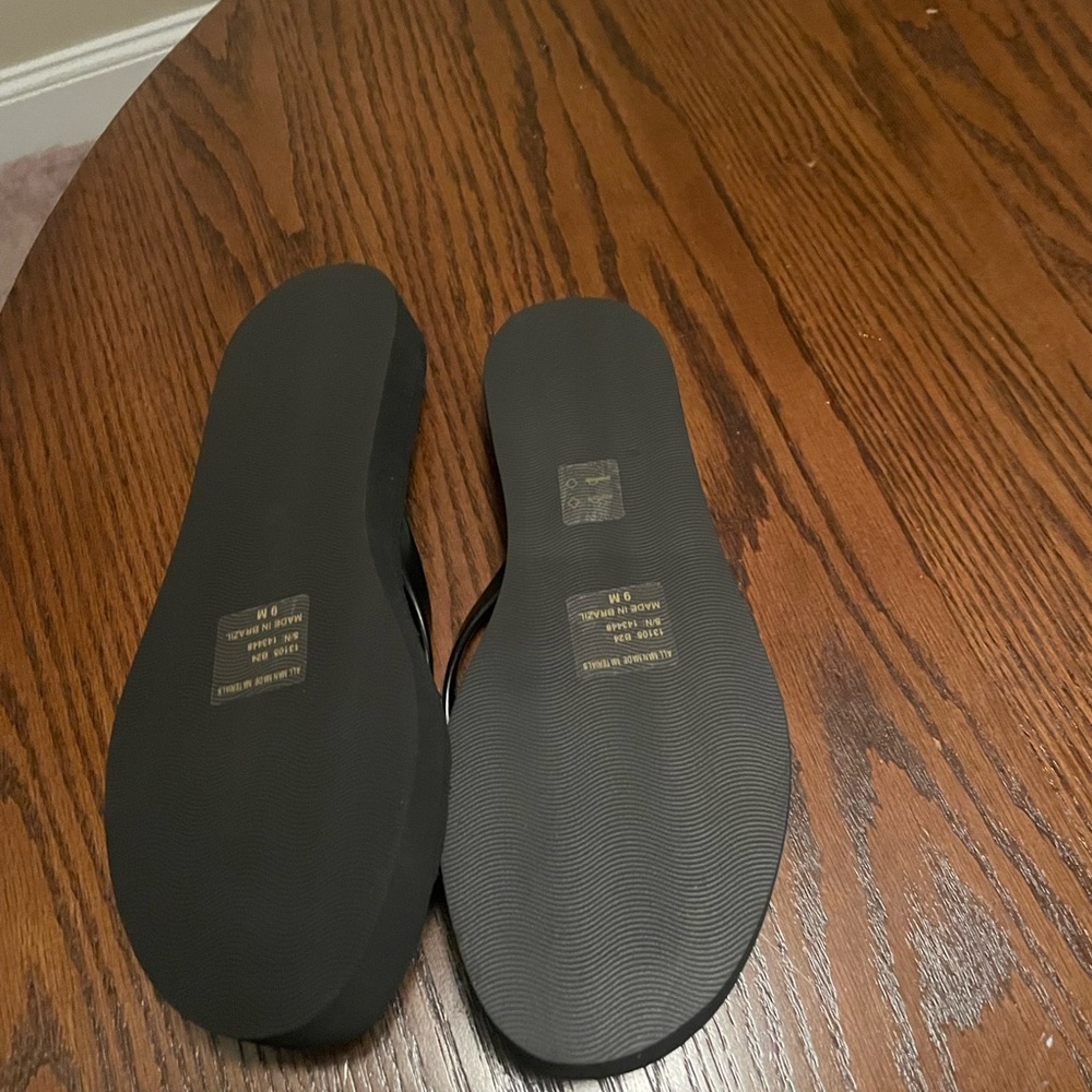 Brand new black platform flip flops . Fits too small is the reason for selling